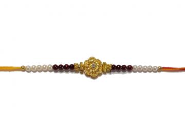 RAKHI Designed With a Golden Flower and Pink Beads for Brother