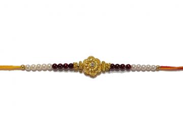 RAKHI Designed With a Golden Flower and Pink Beads for Brother RAKHI Designed With a Golden Flower and Pink Beads for Brother