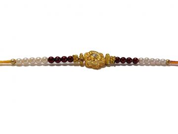 RAKHI Designed With a Golden Flower and Pink Beads for Brother RAKHI Designed With a Golden Flower and Pink Beads for Brother