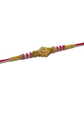 RAKHI Designed With a Golden Flower Pink Beads and White Diamonds RAKHI Designed With a Golden Flower Pink Beads and White Diamonds