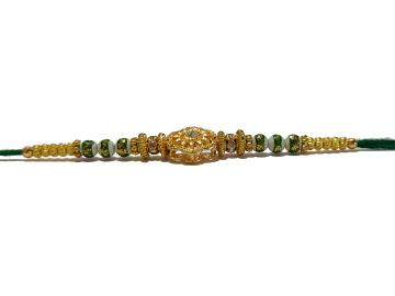 RAKHI Designed With a Golden Flower Green Beads and White Diamonds