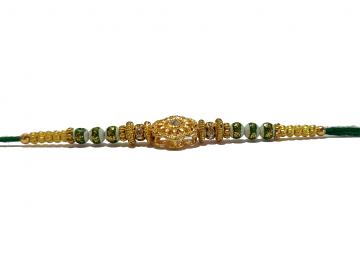 RAKHI Designed With a Golden Flower Green Beads and White Diamonds