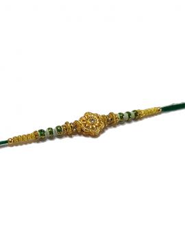 RAKHI Designed With a Golden Flower Green Beads and White Diamonds