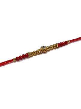 Diamond RAKHI Designed With Golden and Red Beads Diamond RAKHI Designed With Golden and Red Beads