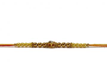 Diamond RAKHI Designed W/ Golden and Yellow Beads