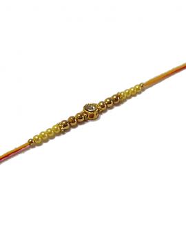 Diamond RAKHI Designed W/ Golden and Yellow Beads Diamond RAKHI Designed W/ Golden and Yellow Beads