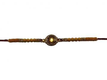 Aesthetic Rakhi W/ a Amber Gem Stone Surrounded in Gold Aesthetic Rakhi W/ a Amber Gem Stone Surrounded in Gold