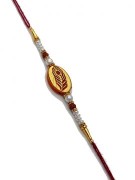 Peacock Feather Carved in Gold RAKHI with Rudraksha and White Beads Peacock Feather Carved in Gold RAKHI with Rudraksha and White Beads