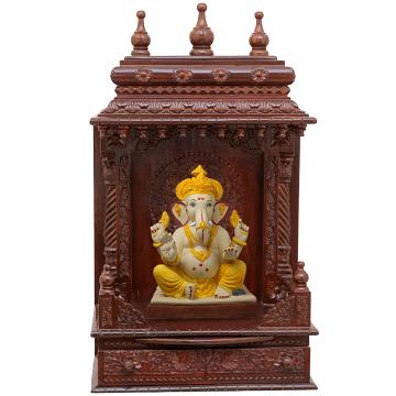 Show the interior of the gopura wooden mandir with a deity or spiritual figure promiently displayed