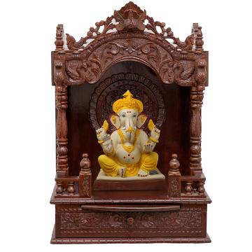Show the interior of the mandap wooden mandir with a deity or spiritual figure prominently displayed.