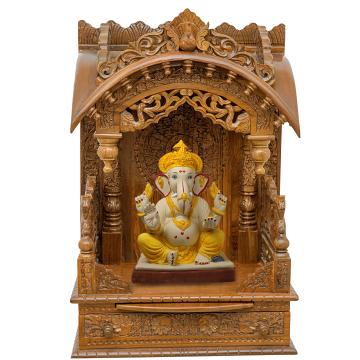 Show the interior of the torana wooden mandir with a deity or spiritual figure prominently displayed. Show the interior of the torana wooden mandir with a deity or spiritual figure prominently displayed.