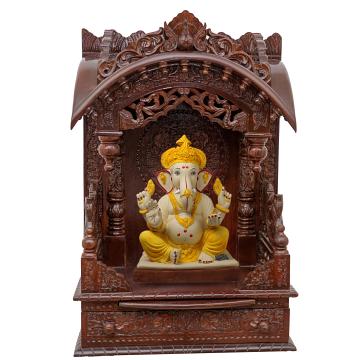 Show the interior of the torana wooden mandir with a deity or spiritual figure prominently displayed.
