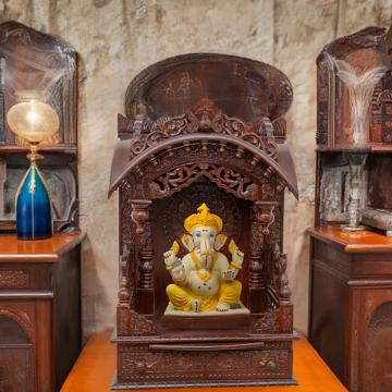 Illustrate the torana mandir in a lifestyle setting, such as a well-designed living room or prayer room Illustrate the torana mandir in a lifestyle setting, such as a well-designed living room or prayer room