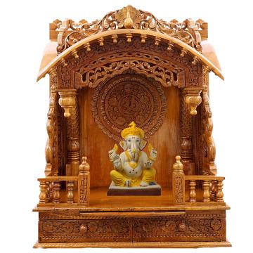 Show the interior of the torana wooden mandir with a deity or spiritual figure prominently displayed.