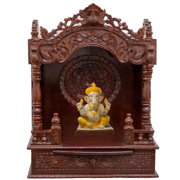 Show the interior of the mandap wooden mandir with a deity or spiritual figure prominently displayed.