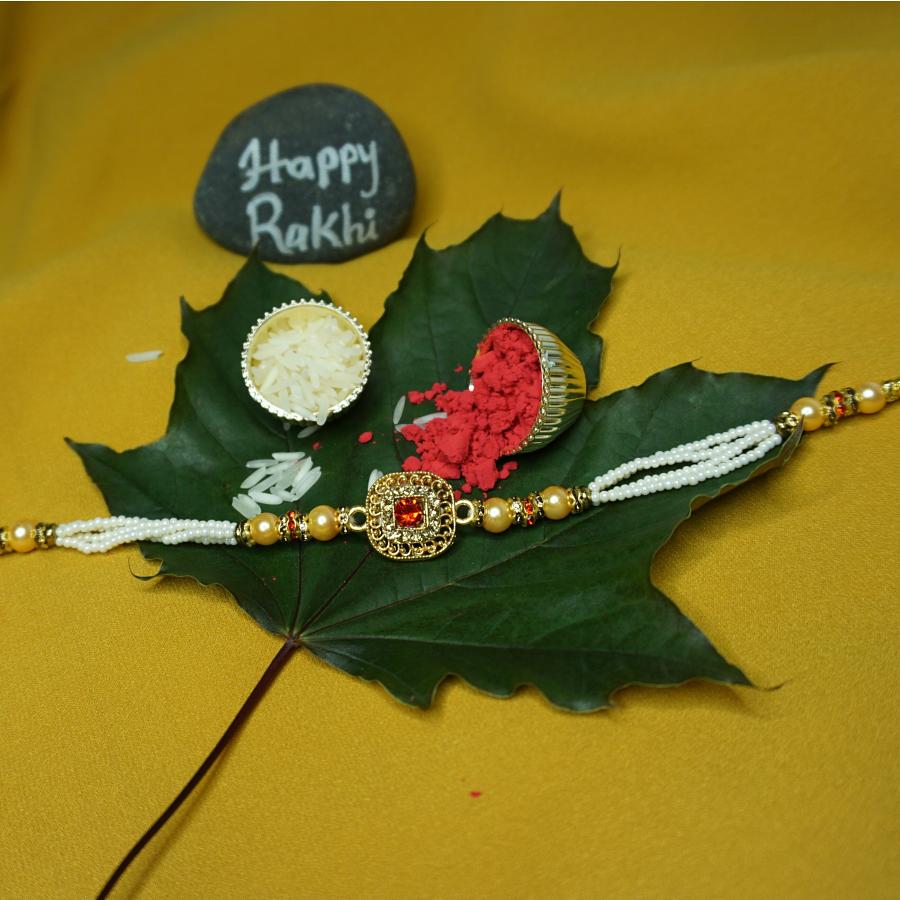 Lustrous Red Ruby Bracelet Rakhi Surrounded by Diamonds + Roli & Chaval
