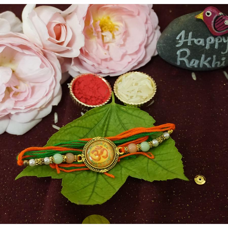 Affectionate Antique Om Rakhi W/ Beautiful Beads + Roli & Chaval Affectionate Antique Om Rakhi W/ Beautiful Beads + Roli & Chaval