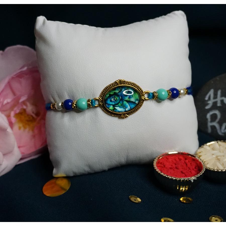 Turquoise Gem Rakhi With Beautiful Blue Beads + Roli & Chaval Turquoise Gem Rakhi With Beautiful Blue Beads + Roli & Chaval