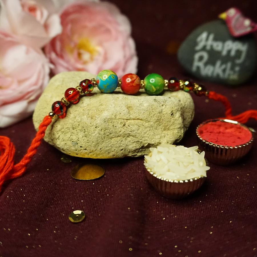 Rakhi made With Delicate Round Shaped Indonesian Beads + Roli and Chaval