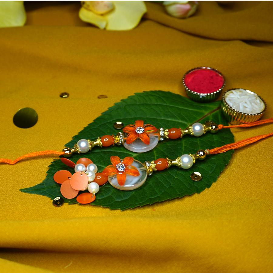 Elegant Bhaiya Bhabhi Rakhi With An Orange Flower on stone + Roli/Chaval