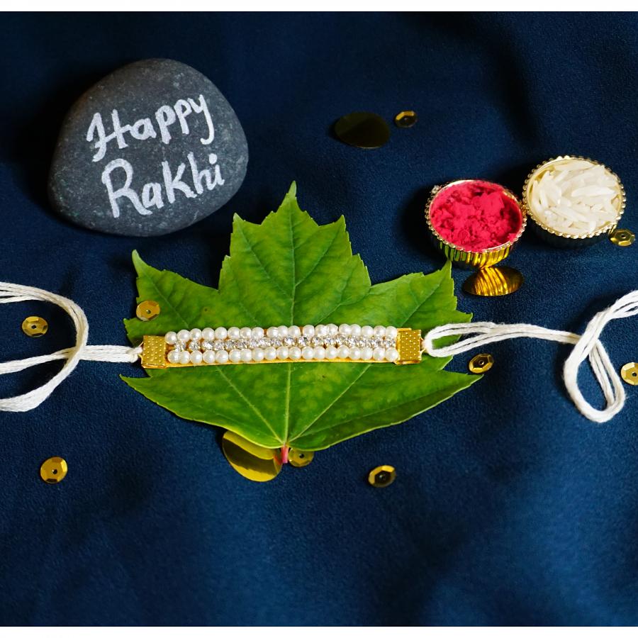 Simple Diamond RAKHI Designed With White Beads + Roli & Chaval Simple Diamond RAKHI Designed With White Beads + Roli & Chaval