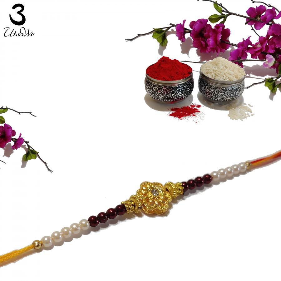 RAKHI Designed With a Golden Flower and Brown Beads for Brother RAKHI Designed With a Golden Flower and Brown Beads for Brother