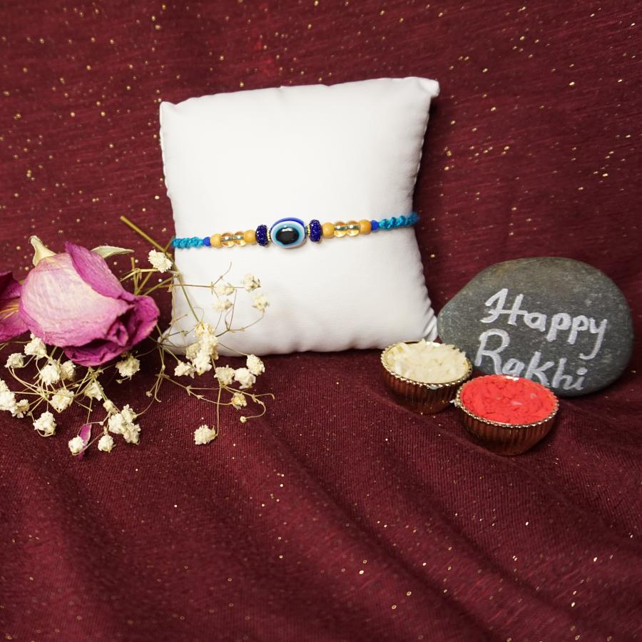 Beautiful Evil Eye Rakhi With Delicate Beads and Roli + Chaval