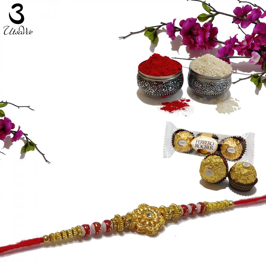 RAKHI Designed With a Golden Flower Pink Beads and White Diamonds RAKHI Designed With a Golden Flower Pink Beads and White Diamonds