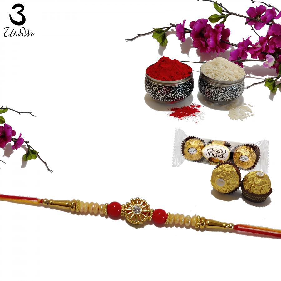 RAKHI Crafted in Gold W/ Pearls Red Beads and a Diamond RAKHI Crafted in Gold W/ Pearls Red Beads and a Diamond
