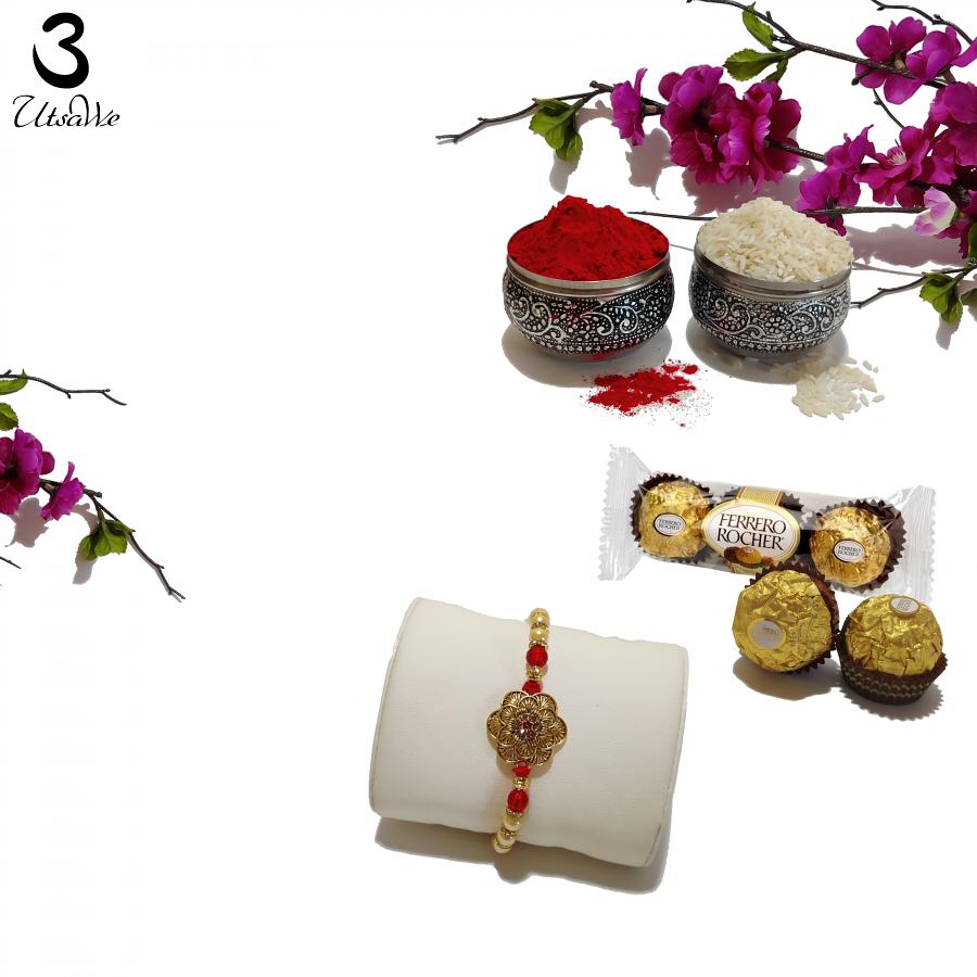 Beautiful Flower Rakhi W/ an embedded Emerald like Pearls + Roli & Chaval Beautiful Flower Rakhi W/ an embedded Emerald like Pearls + Roli & Chaval