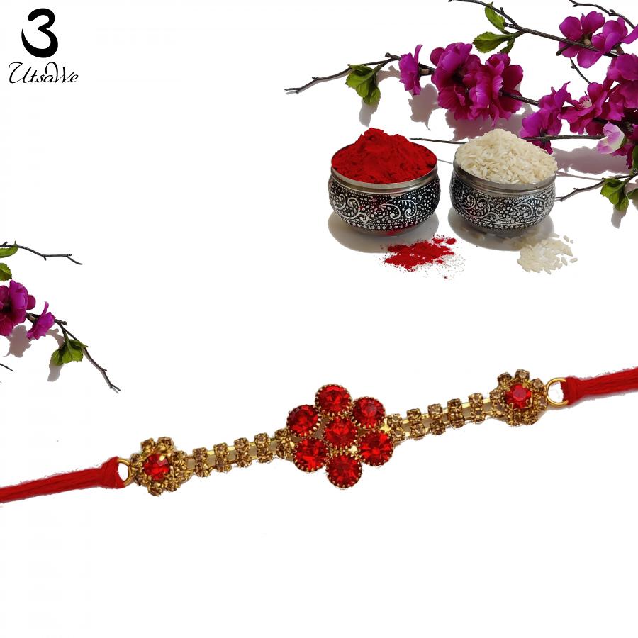 Blossom Ruby Rakhi Entwined Gracefully W/ Umber diamonds + Roli & Chaval Blossom Ruby Rakhi Entwined Gracefully W/ Umber diamonds + Roli & Chaval