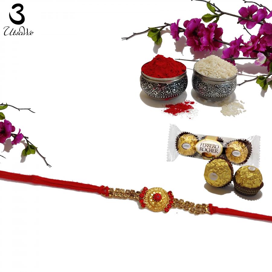 Premium Gold Pended Rakhi W/ Radiant Ruby Embellishment + Roli & Chaval Premium Gold Pended Rakhi W/ Radiant Ruby Embellishment + Roli & Chaval