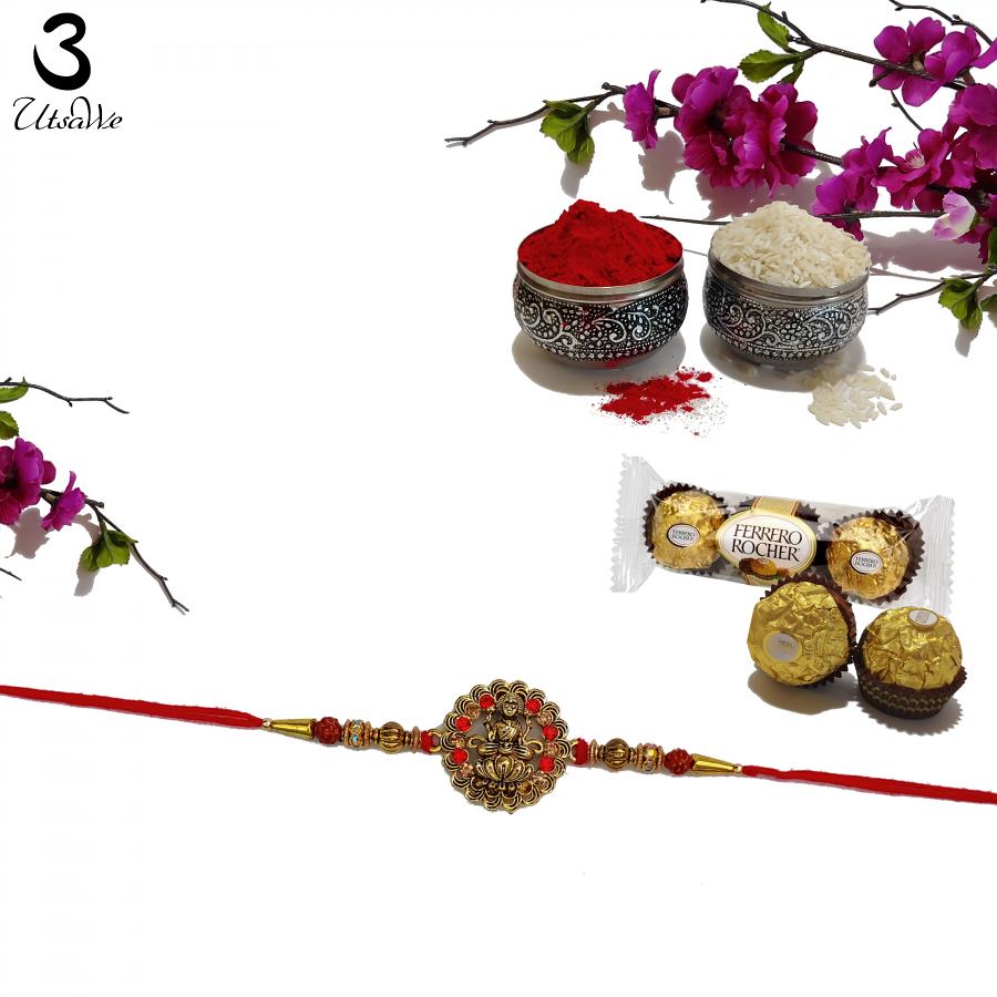 Golden Laxmi Rakhi Adorned with Intricate Ruby + Roli & Chaval