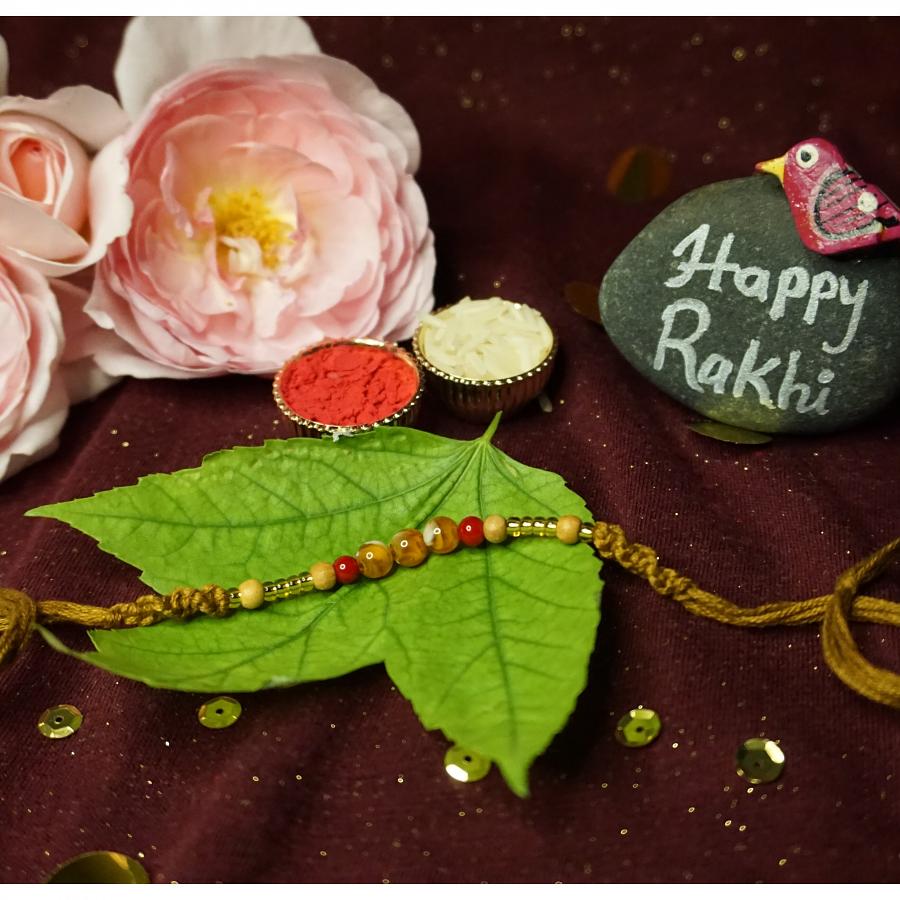 Delightful Rakhi Made With Luminous Pearls which comes with Roli + Chaval