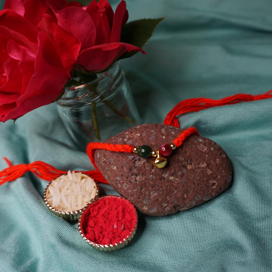 Cute Beads rakhi with small Ghungroo + Roli & Chaval Cute Beads rakhi with small Ghungroo + Roli & Chaval
