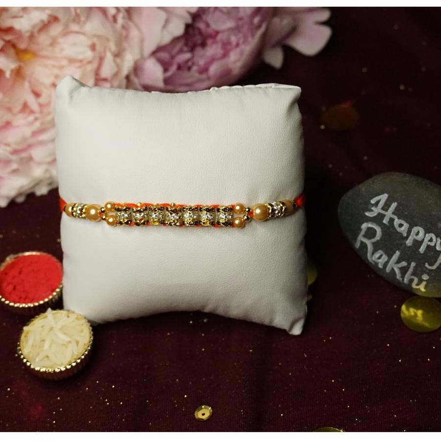 Exquisite Golden Rakhi With Diamonds and Beads + Roli & Chaval