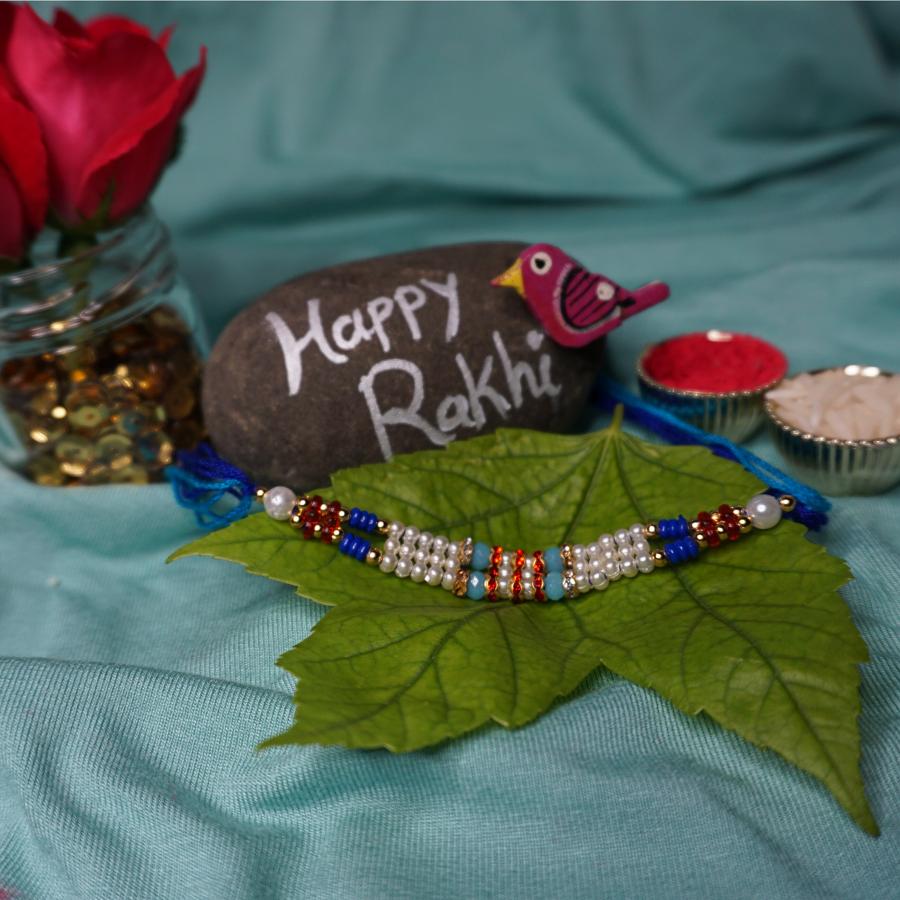 Attractive Beads Rakhi with Beautiful Blue and white Beads / Roli + Chaval Attractive Beads Rakhi with Beautiful Blue and white Beads / Roli + Chaval