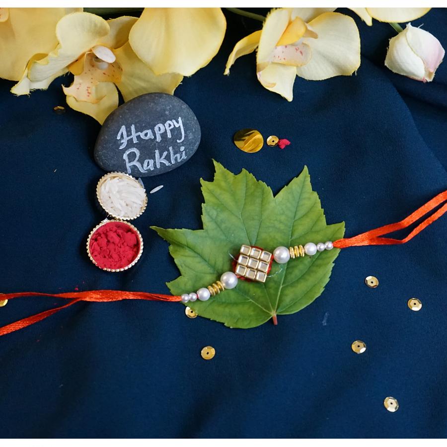 Delicate Kundan Rakhi With White Pearls + Roli & Chaval Delicate Kundan Rakhi With White Pearls + Roli & Chaval