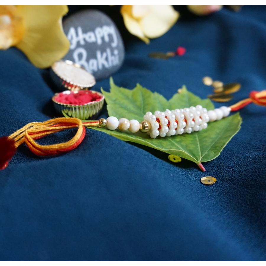 Beautiful Rakhi Made With White Beads + Roli and Chaval Beautiful Rakhi Made With White Beads + Roli and Chaval