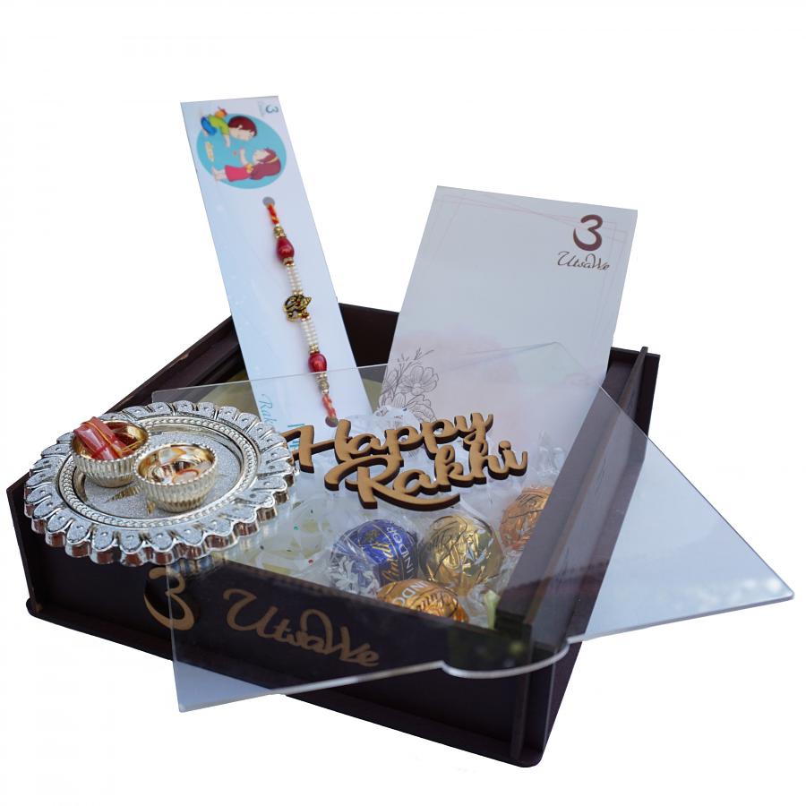 UtsaWe GIFT HAMPER - Golden Ganesh Rakhi W/ Beautiful Red and White Beads UtsaWe GIFT HAMPER - Golden Ganesh Rakhi W/ Beautiful Red and White Beads