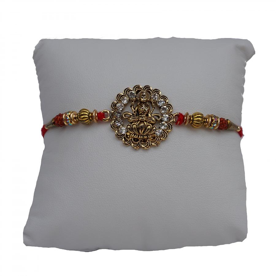 Golden Laxmi Rakhi Adorned with White Diamonds+ Roli & Chaval Golden Laxmi Rakhi Adorned with White Diamonds+ Roli & Chaval