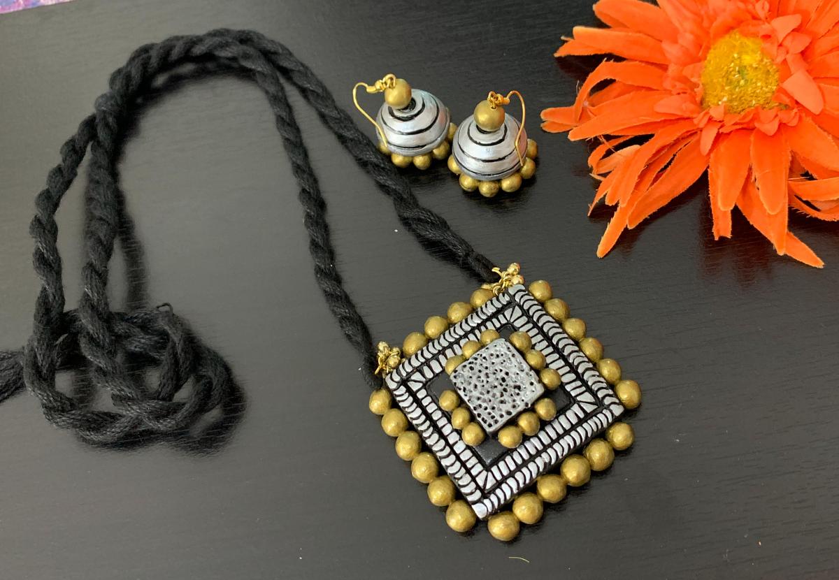 Trendy Gold and SIlver Square pendant in a long Balck rope with Jhumkas!! Trendy Gold and SIlver Square pendant in a long Balck rope with Jhumkas!!