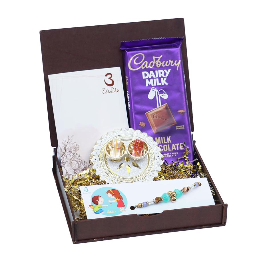 UtsaWe GIFT HAMPER - Adorable Blue Pebble Rakhi With Golden Ghungroo UtsaWe GIFT HAMPER - Adorable Blue Pebble Rakhi With Golden Ghungroo