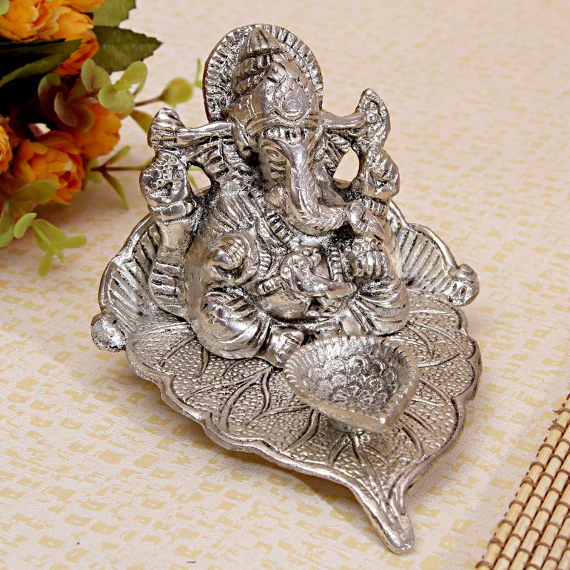 Alluring White Metallic Ganesha with Diya