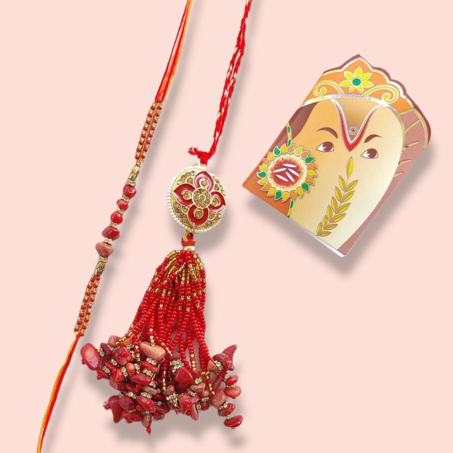 Fancy Lumba Rakhi With Red Pebbles and Beads + Roli & Chaval Fancy Lumba Rakhi With Red Pebbles and Beads + Roli & Chaval