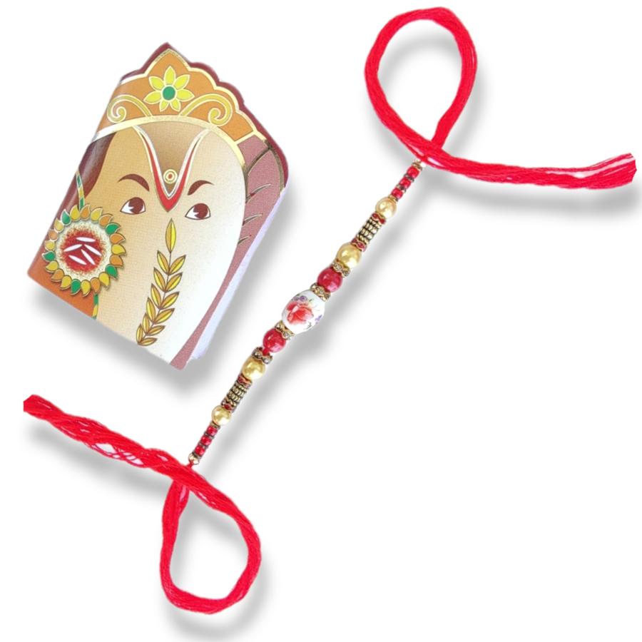 Elegant Flower Stone Rakhi With Handcrafted Ornaments + Roli & Chaval Elegant Flower Stone Rakhi With Handcrafted Ornaments + Roli & Chaval