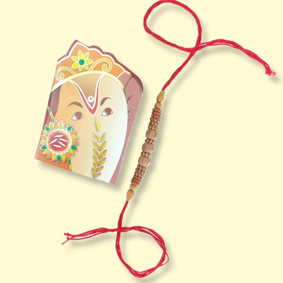 Wooden Rudraksha Rakhi With Handcrafted Ornaments + Roli & Chaval Wooden Rudraksha Rakhi With Handcrafted Ornaments + Roli & Chaval