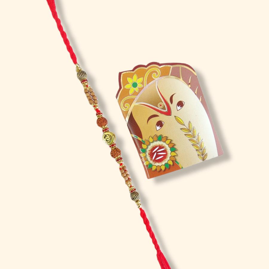 OM Rakhi with Rudraksha and Tulsi Bead + Roli & Chaval OM Rakhi with Rudraksha and Tulsi Bead + Roli & Chaval