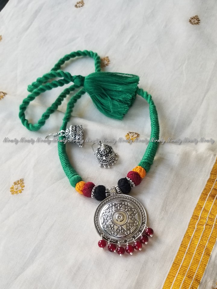 Green dori necklace with oxidized metal pendant and matching earrings Green dori necklace with oxidized metal pendant and matching earrings