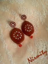 Pearl white on shimmering brick red tear drop clay earrings